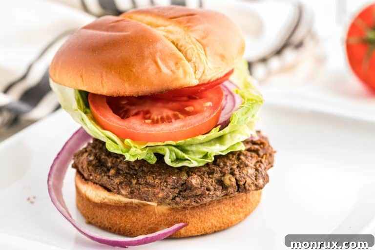 A delicious lentil burger served on a toasted bun with fresh tomato and lettuce, perfect for a plant-based meal.