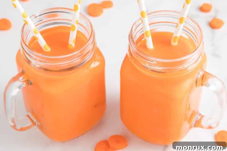 Two mason jar mugs with carrot juice, each has two straws.