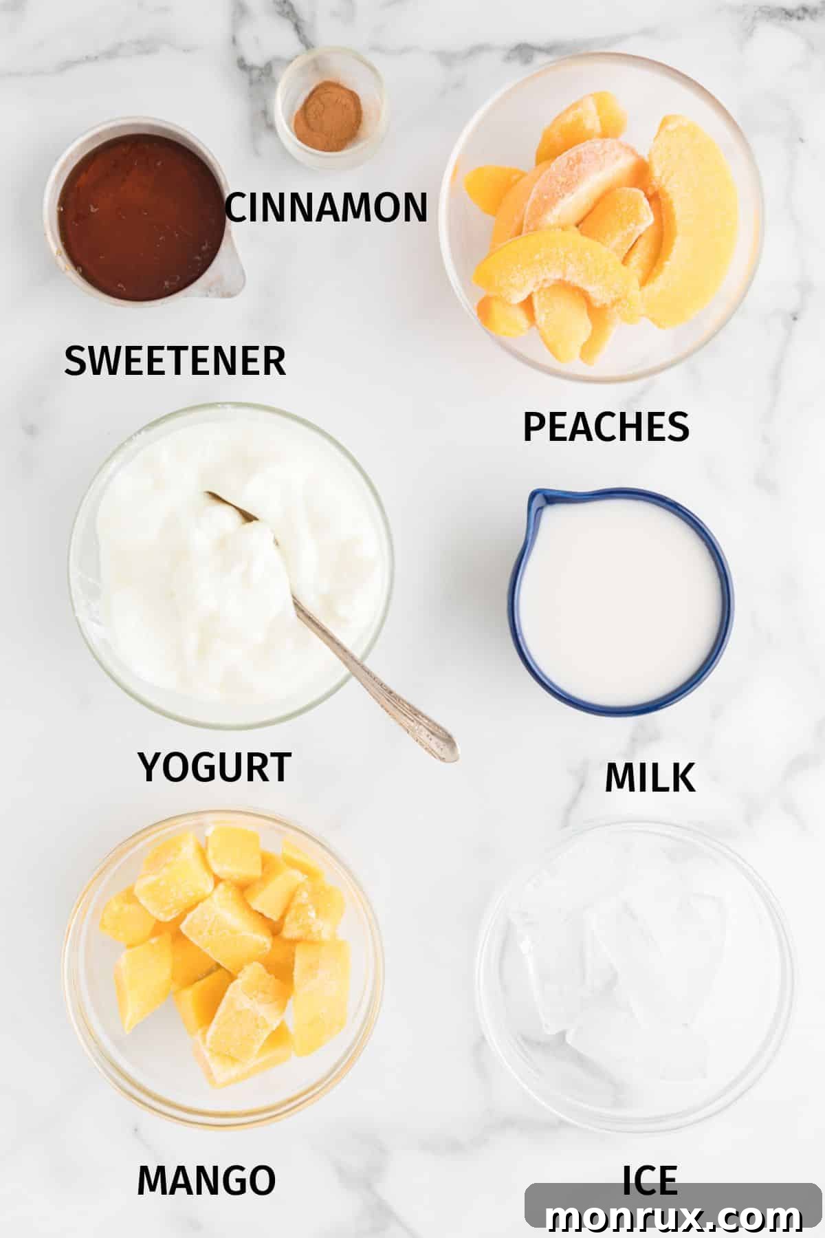 All the fresh and frozen ingredients for a homemade mango peach smoothie laid out on a clean surface, ready for blending.