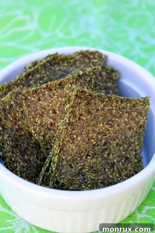 Crisp and tasty green juice pulp crackers neatly arranged in a white bowl, ready to be enjoyed as a healthy snack.