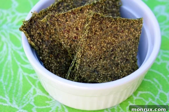 Crisp and tasty green juice pulp crackers that are vegan and gluten-free, served in a bowl. Ideal for dehydrator recipes, raw food recipes, and healthy vegan snacks.