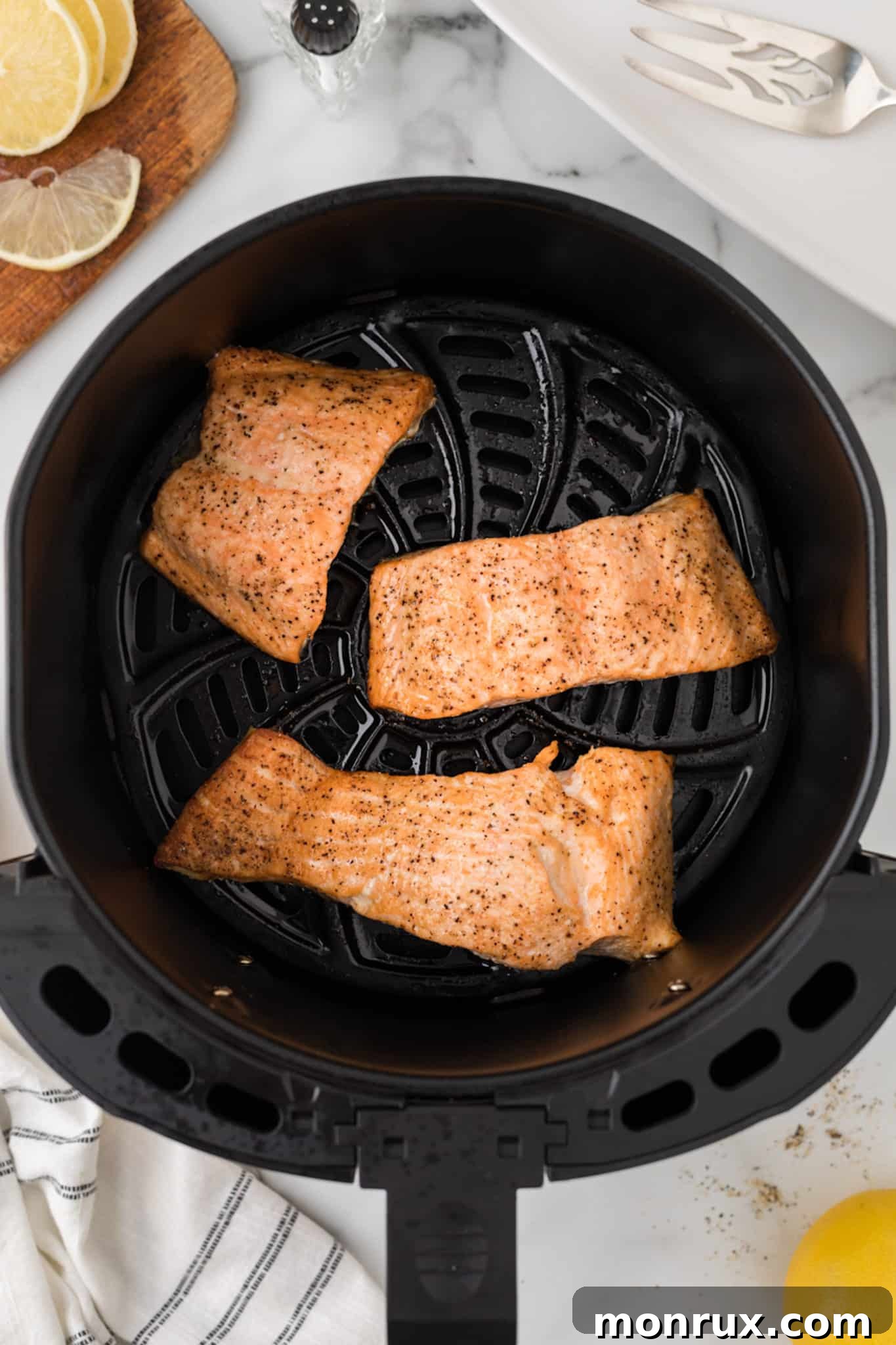 cooked salmon fillets in an air fryer.