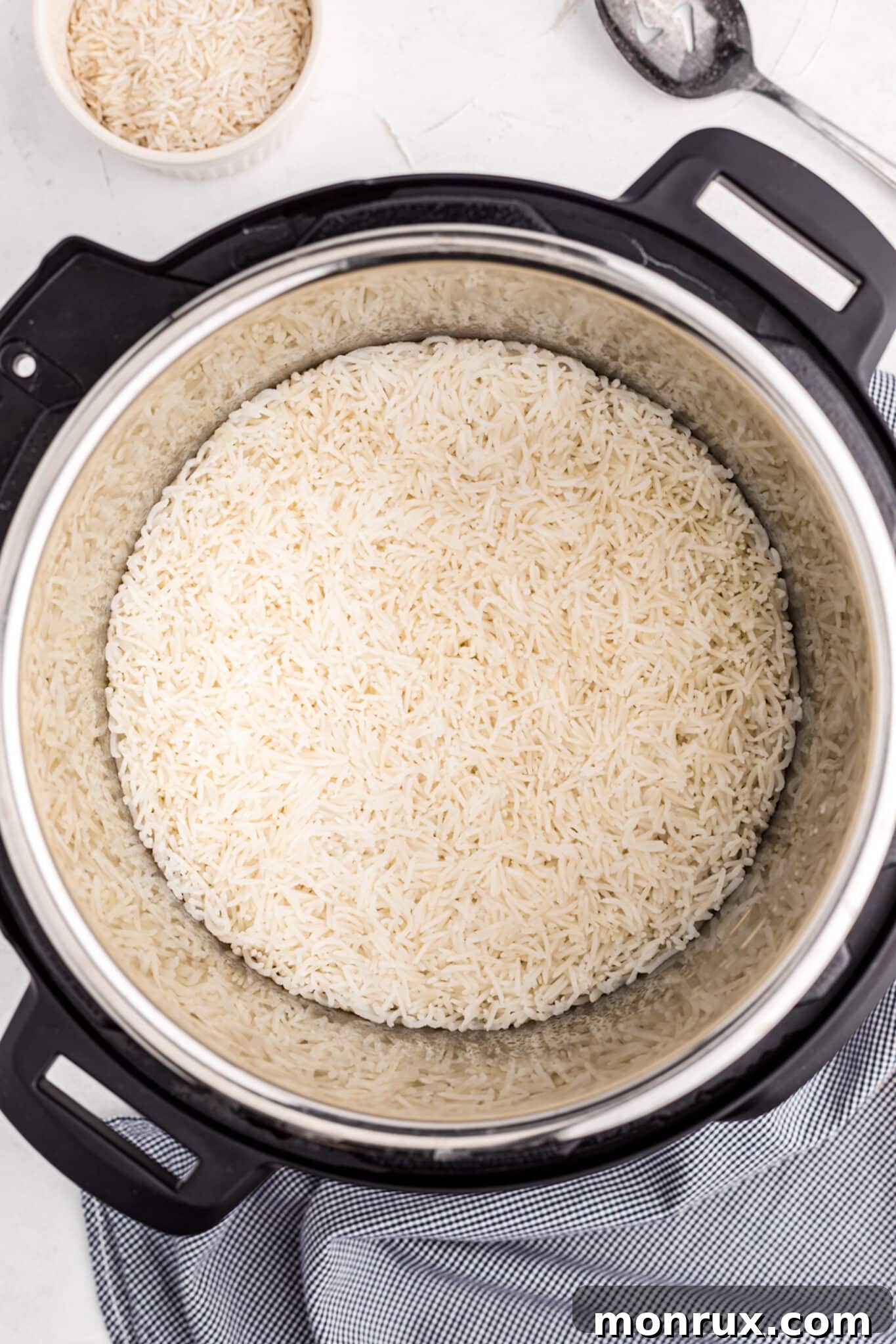 Instant Pot liner with rinsed Basmati rice and precisely measured water, poised for cooking.
