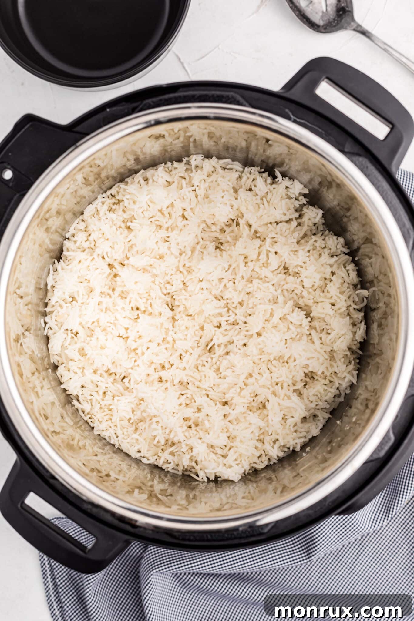 Freshly cooked white Basmati rice inside the Instant Pot, showing its fluffy texture post-pressure release.