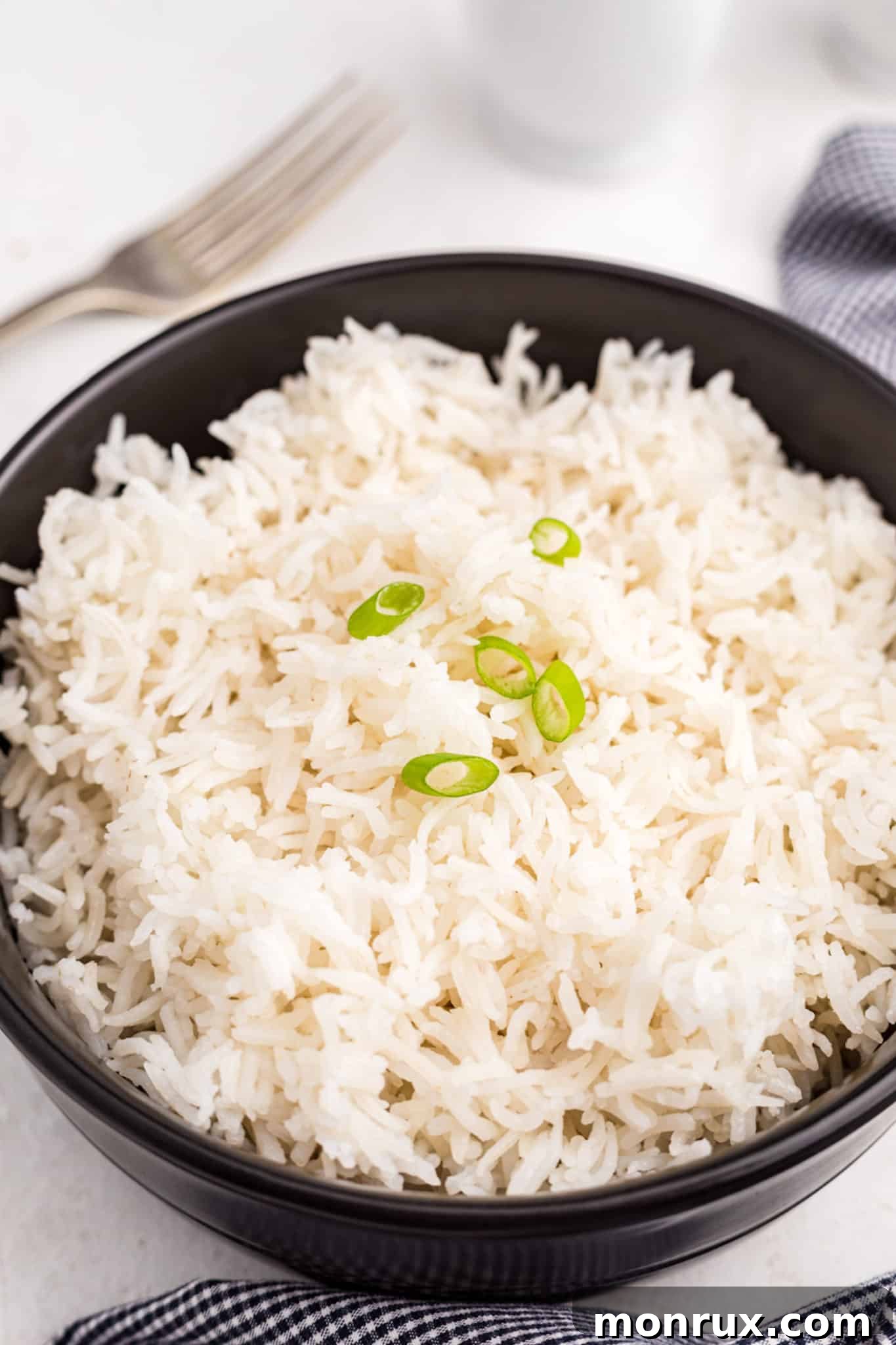 A close-up shot of a serving bowl filled with white Basmati rice cooked to perfection in an Instant Pot.