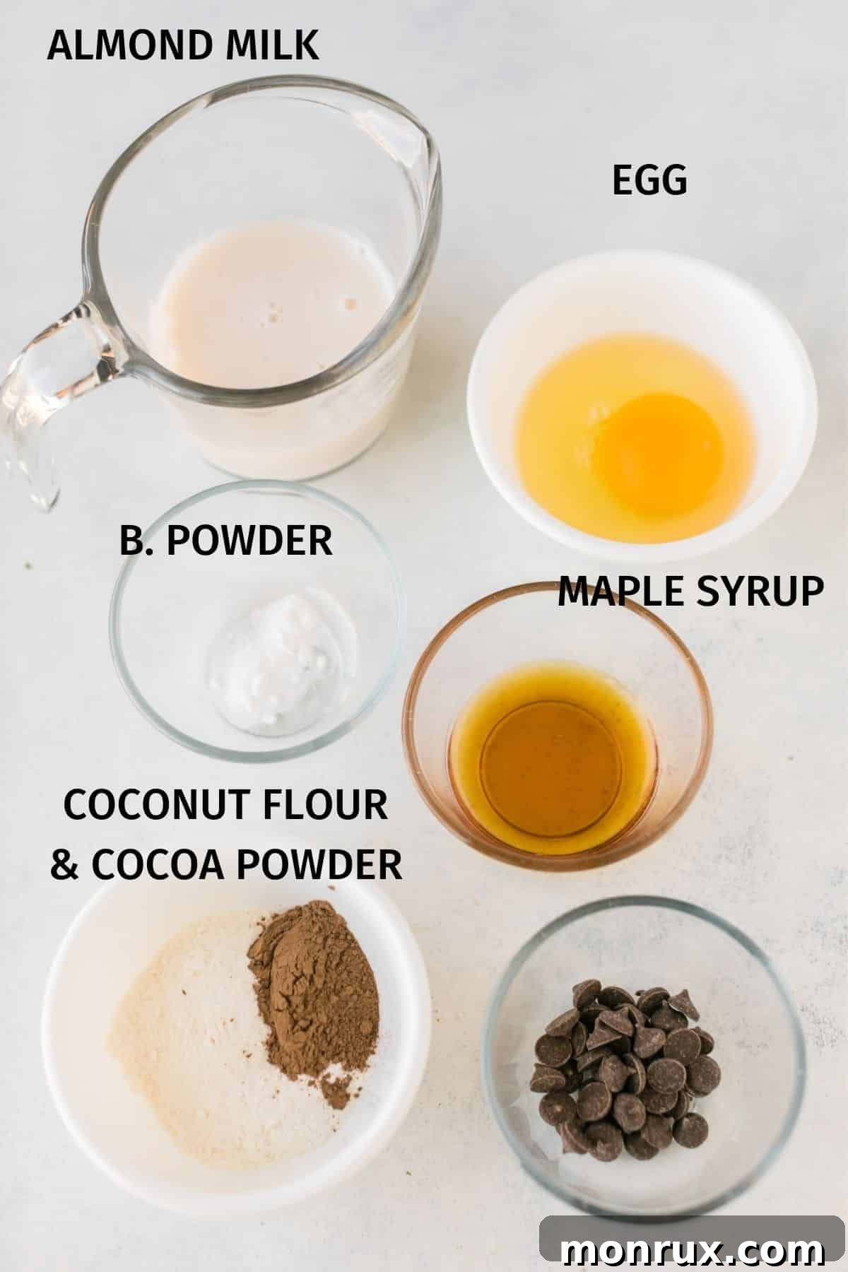 A flat lay photograph of all the ingredients laid out for making a coconut flour mug cake.