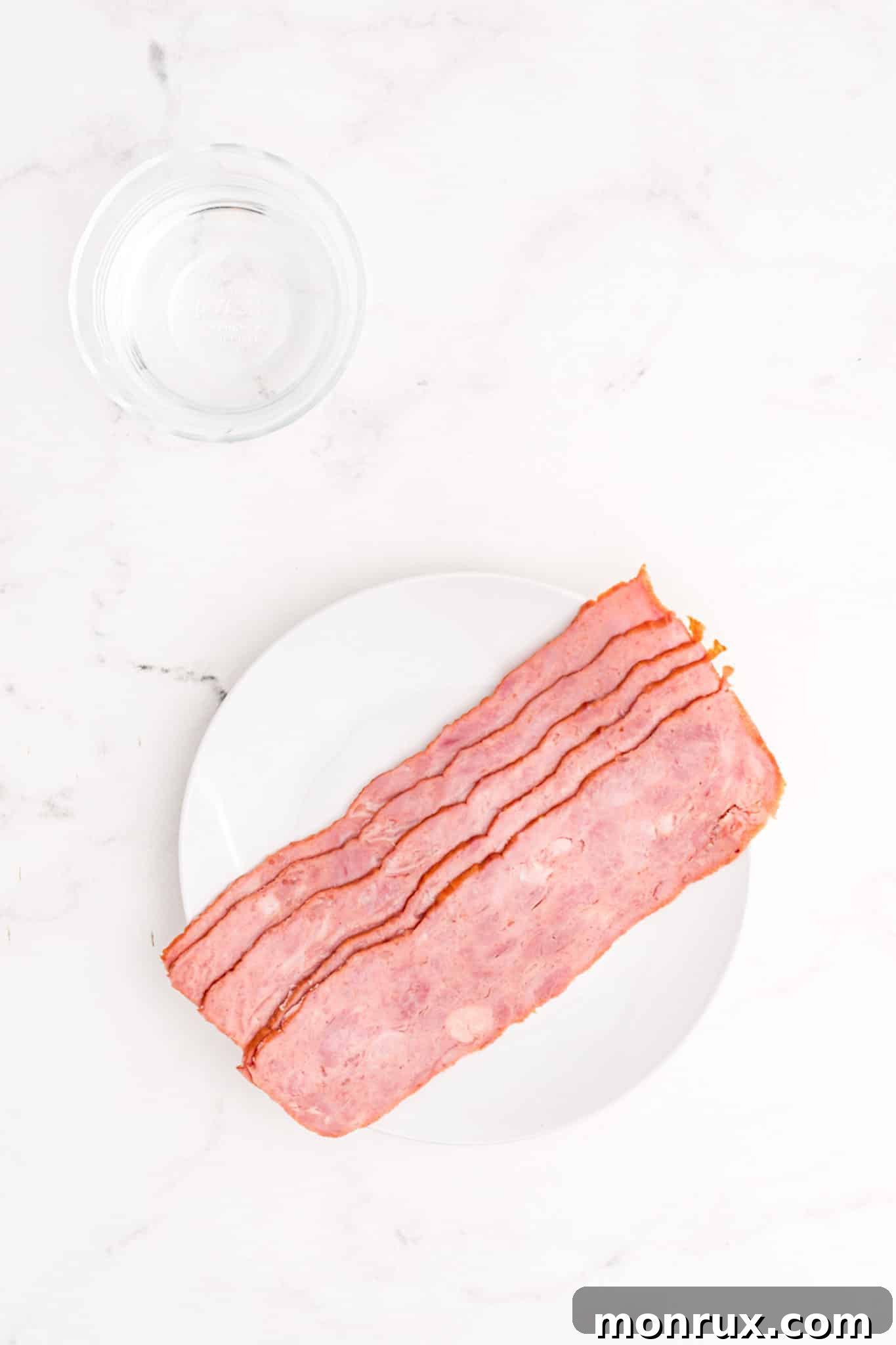 Uncooked turkey bacon slices neatly arranged on a wooden tabletop.