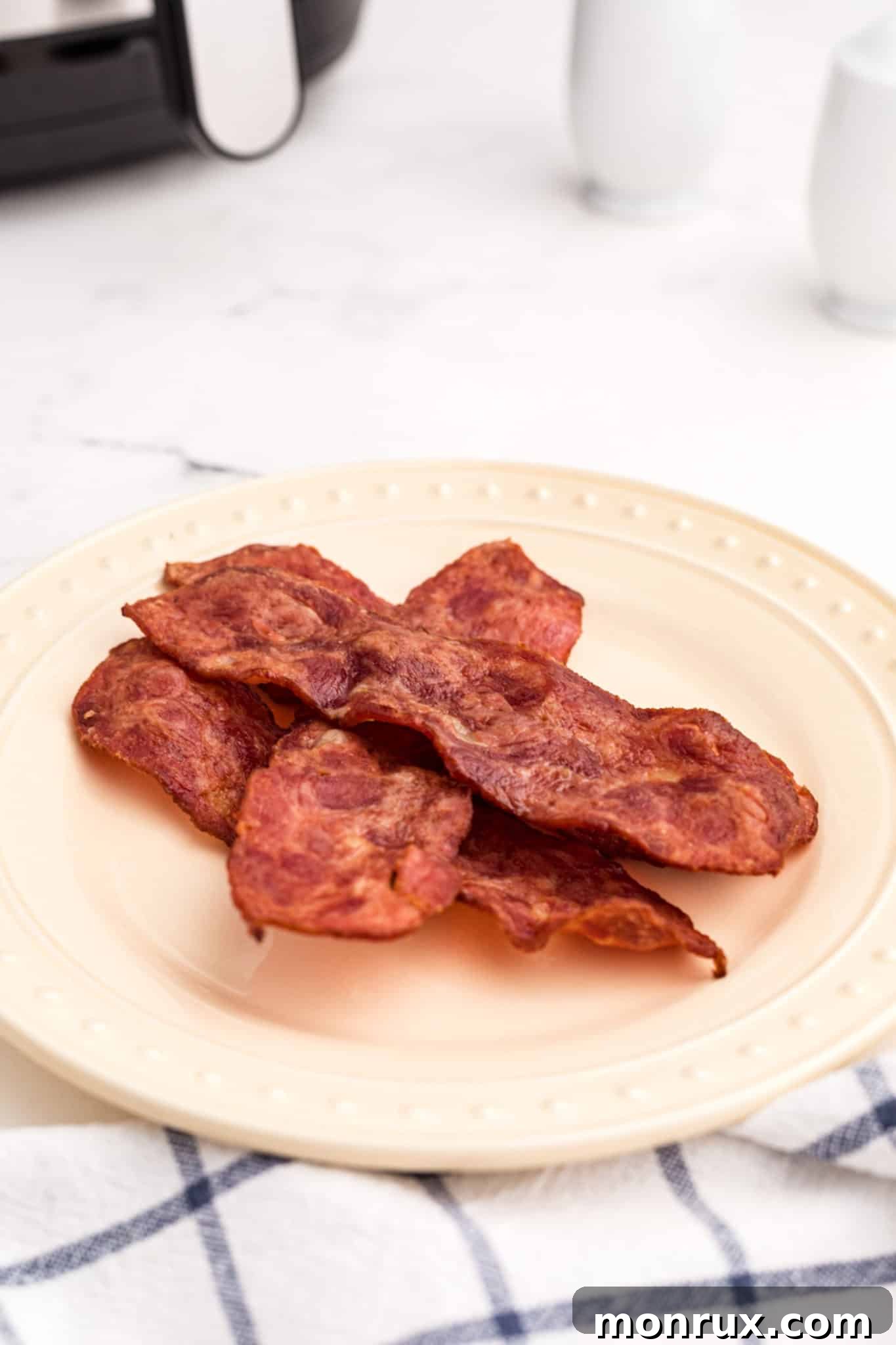 Freshly cooked crispy turkey bacon slices presented beautifully on a plate.