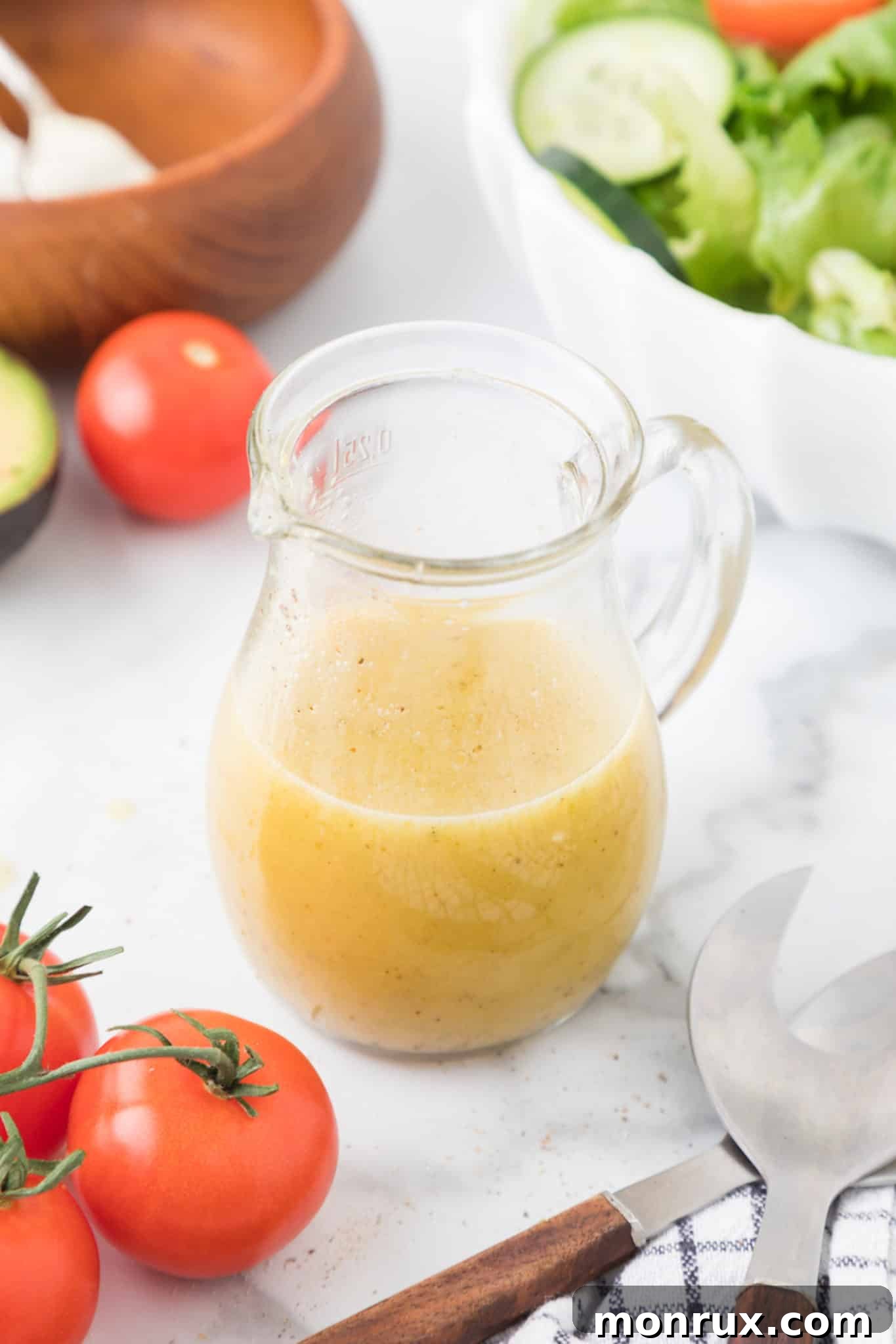 A charming glass jar filled with golden honey mustard dressing, resting on a rustic wooden table, ready to be enjoyed.