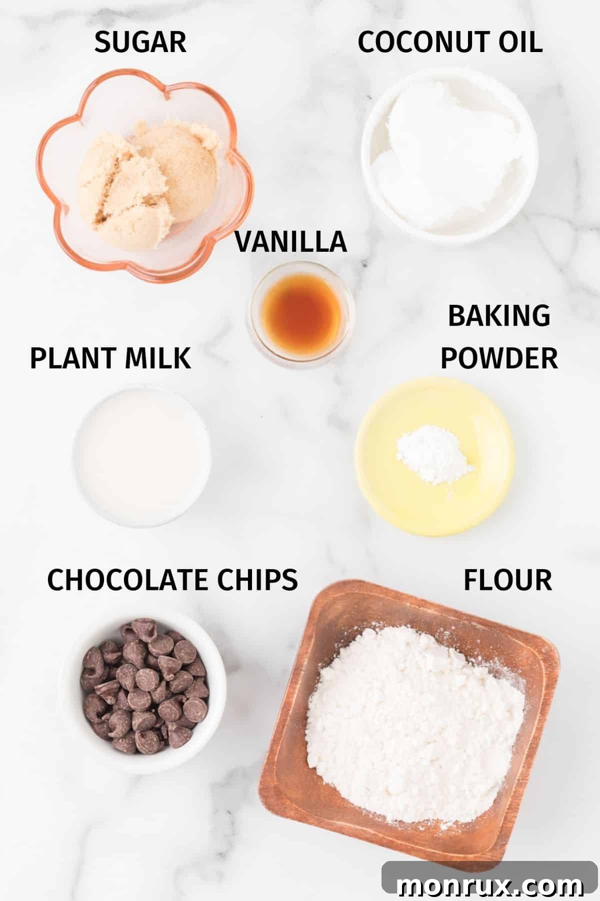 An organized photo of all the labeled key ingredients needed for making a vegan mug cake.