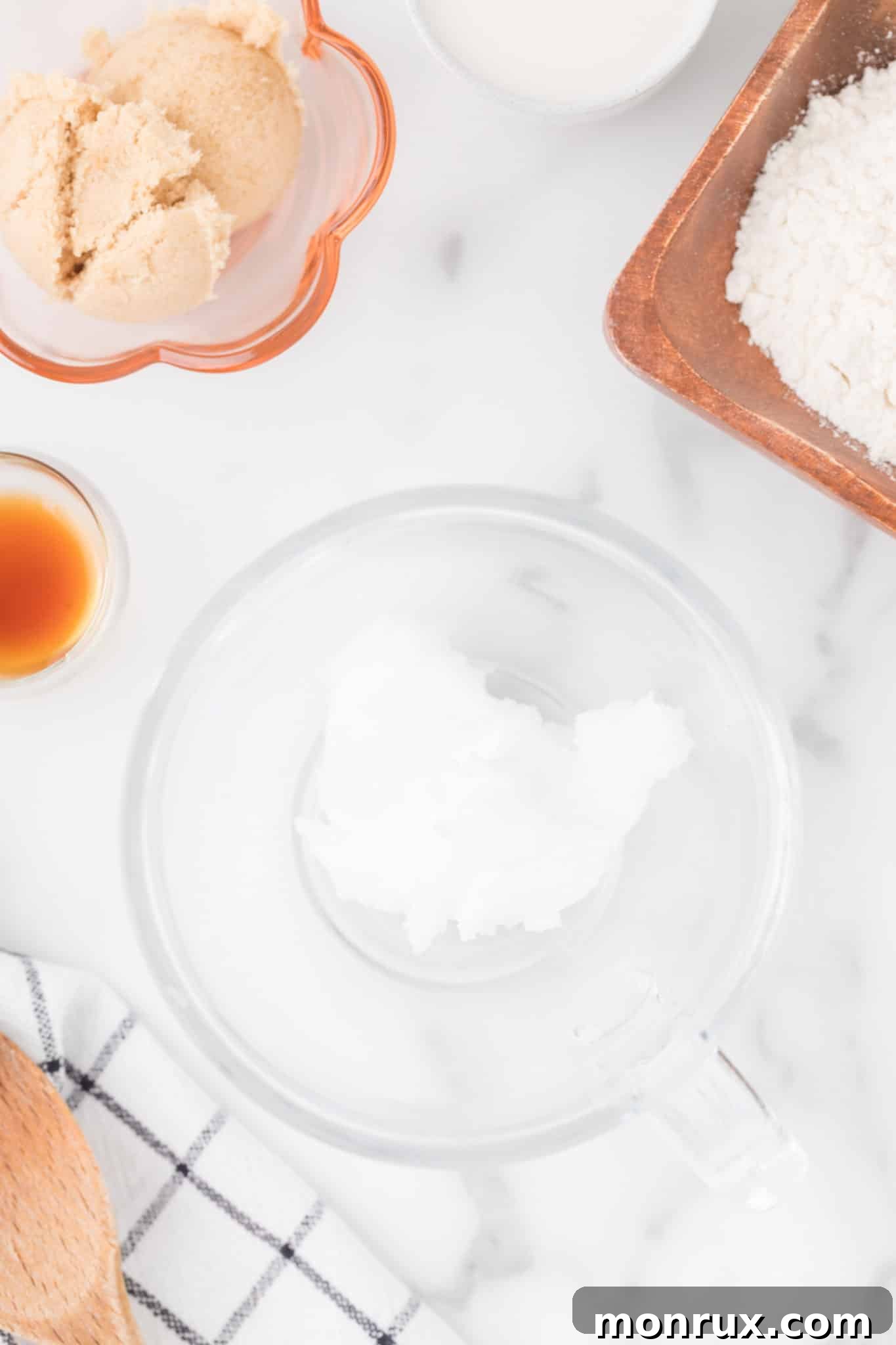All the ingredients for the mug cake being added into a single mug.