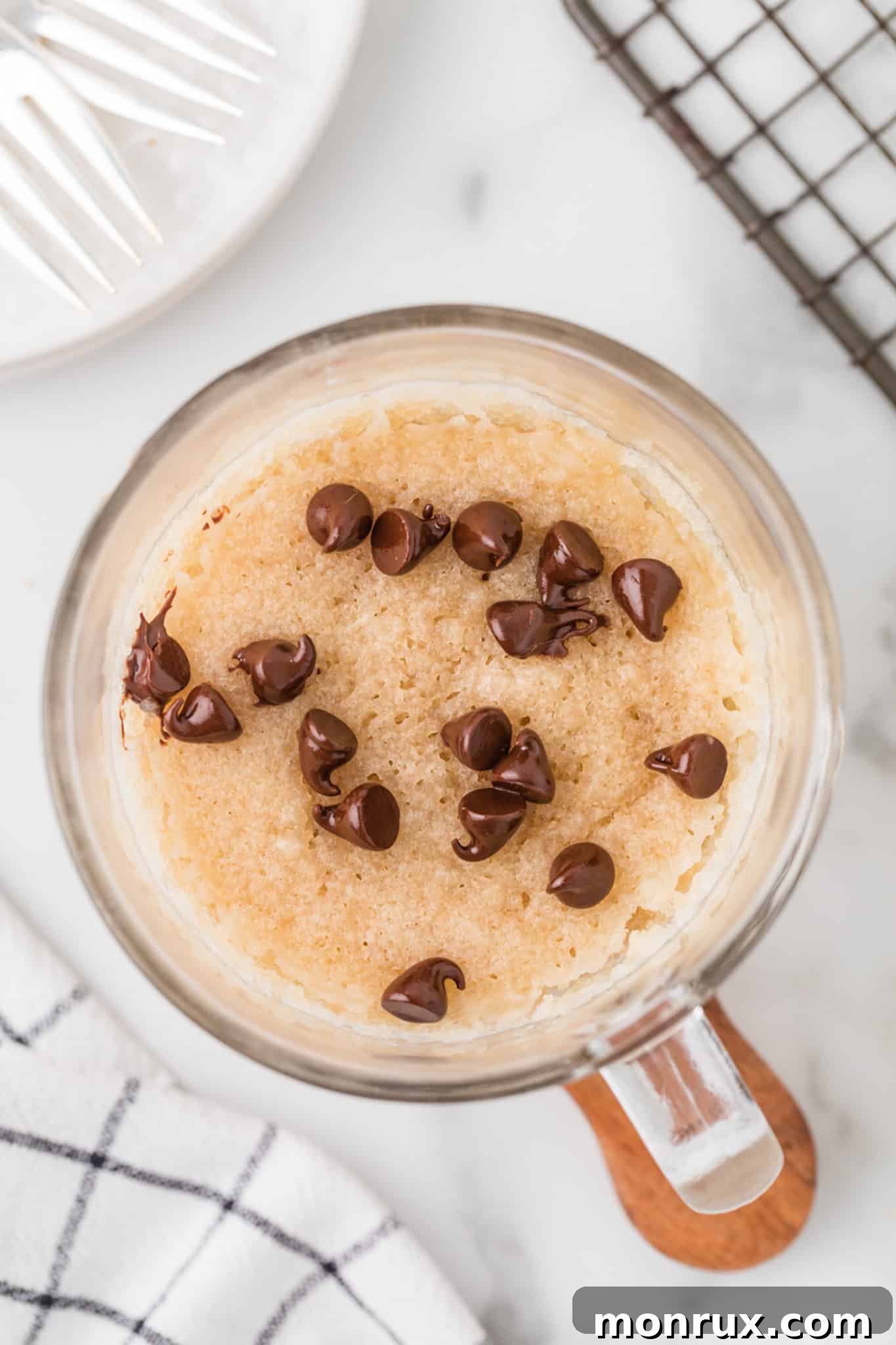 A perfectly risen vegan mug cake fresh from the microwave, ready for toppings.