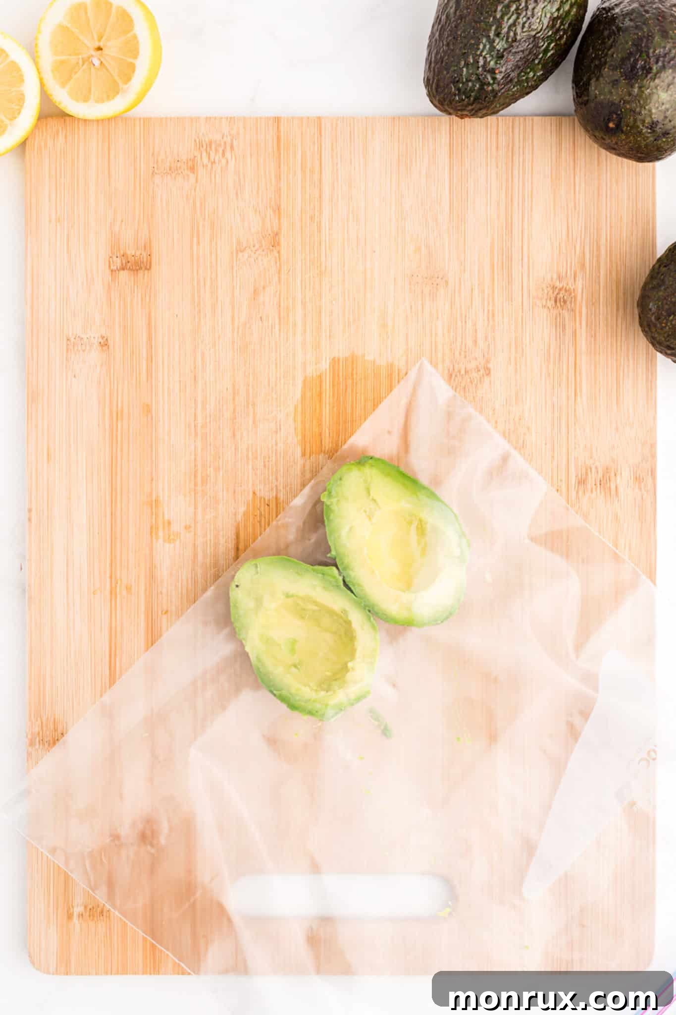 Avocado halves neatly placed in a plastic bag, ready to be put into the freezer for long-term storage.