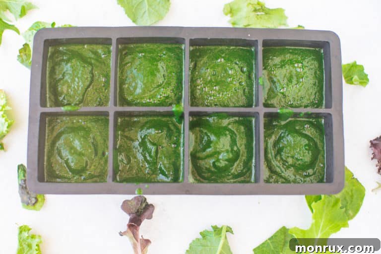 Ice cube tray filled with pureed spinach, ready to be frozen into cubes
