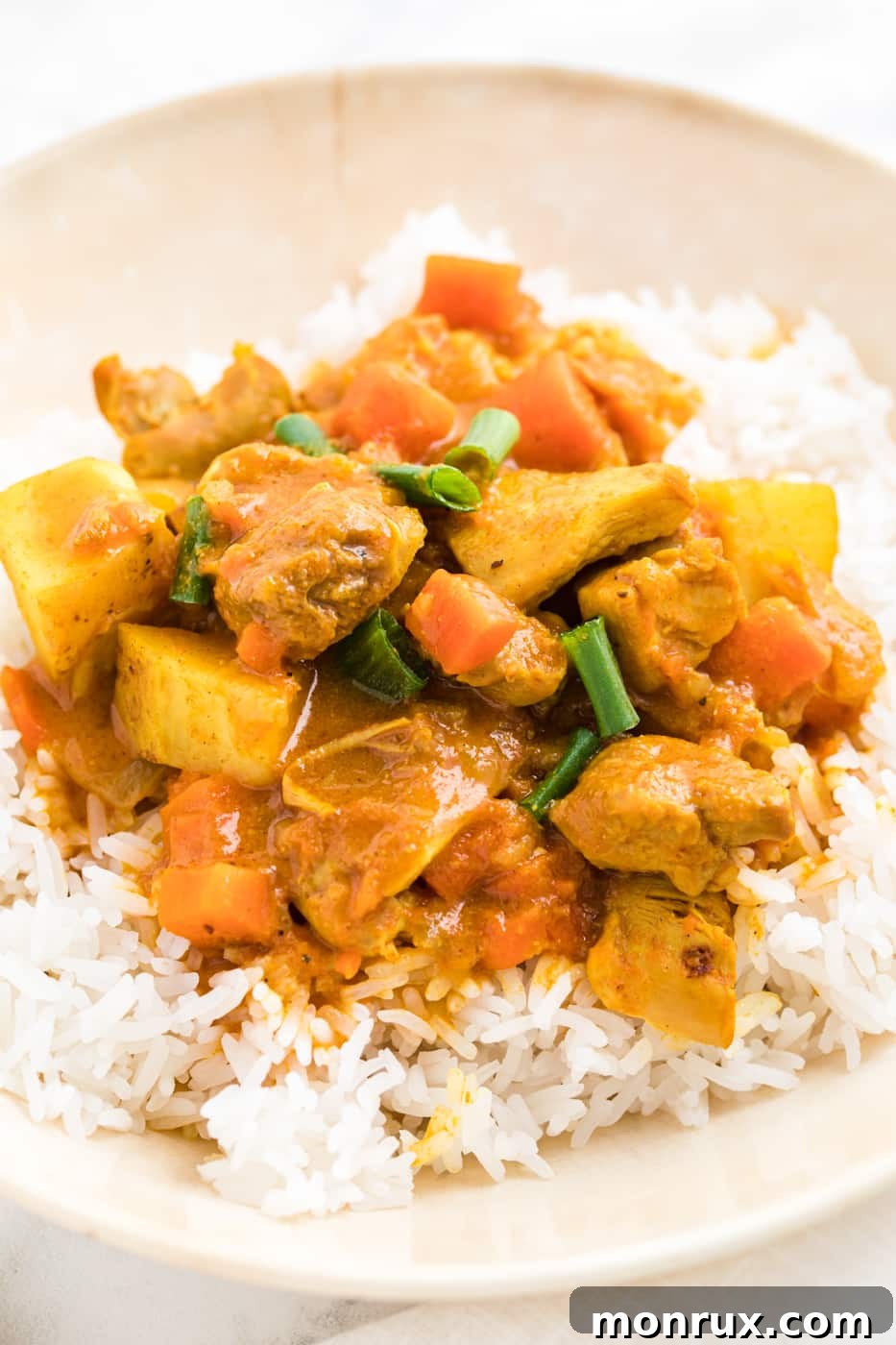 bowl of instant pot chicken curry on top of steamed rice.