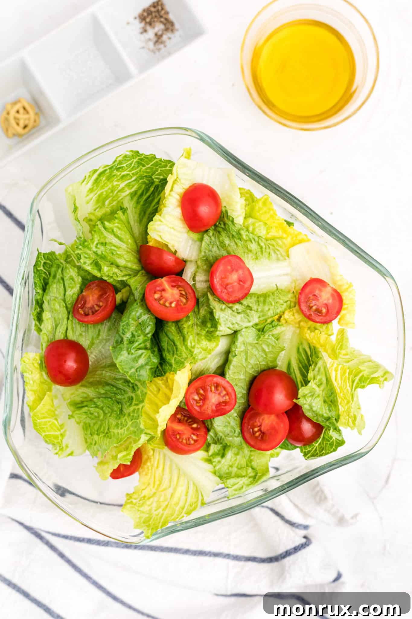 Fresh romaine salad with a simple vinaigrette and vibrant cherry tomatoes, ready to be served.