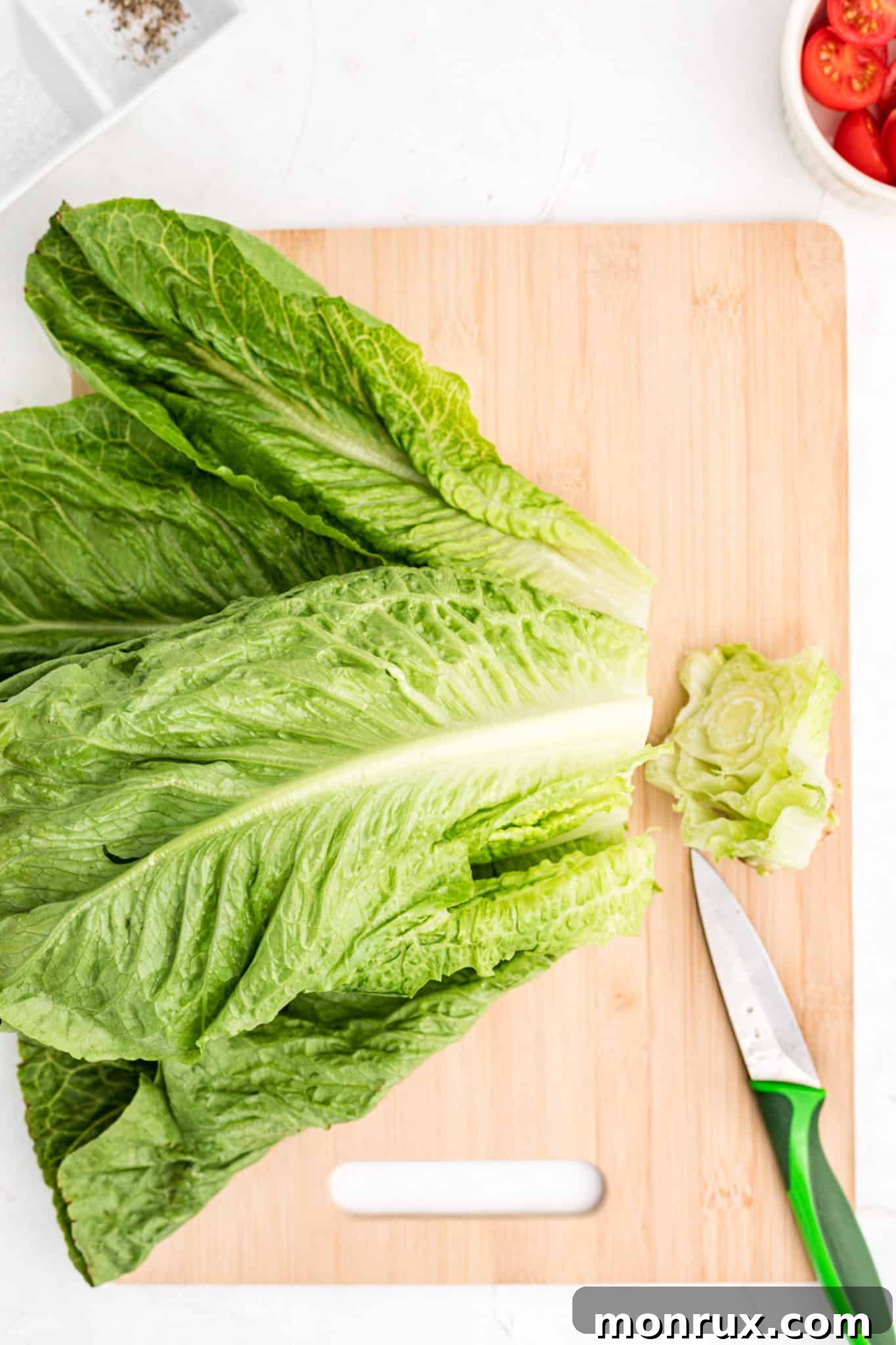 A close-up of a fresh head of romaine lettuce, showcasing its crisp leaves.