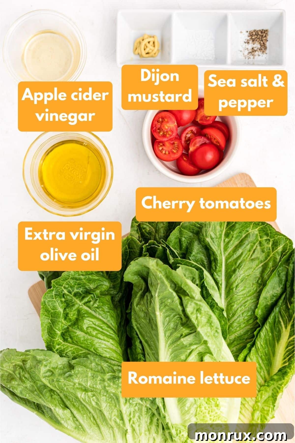 All the necessary ingredients laid out for making a fresh romaine salad with a homemade vinaigrette.