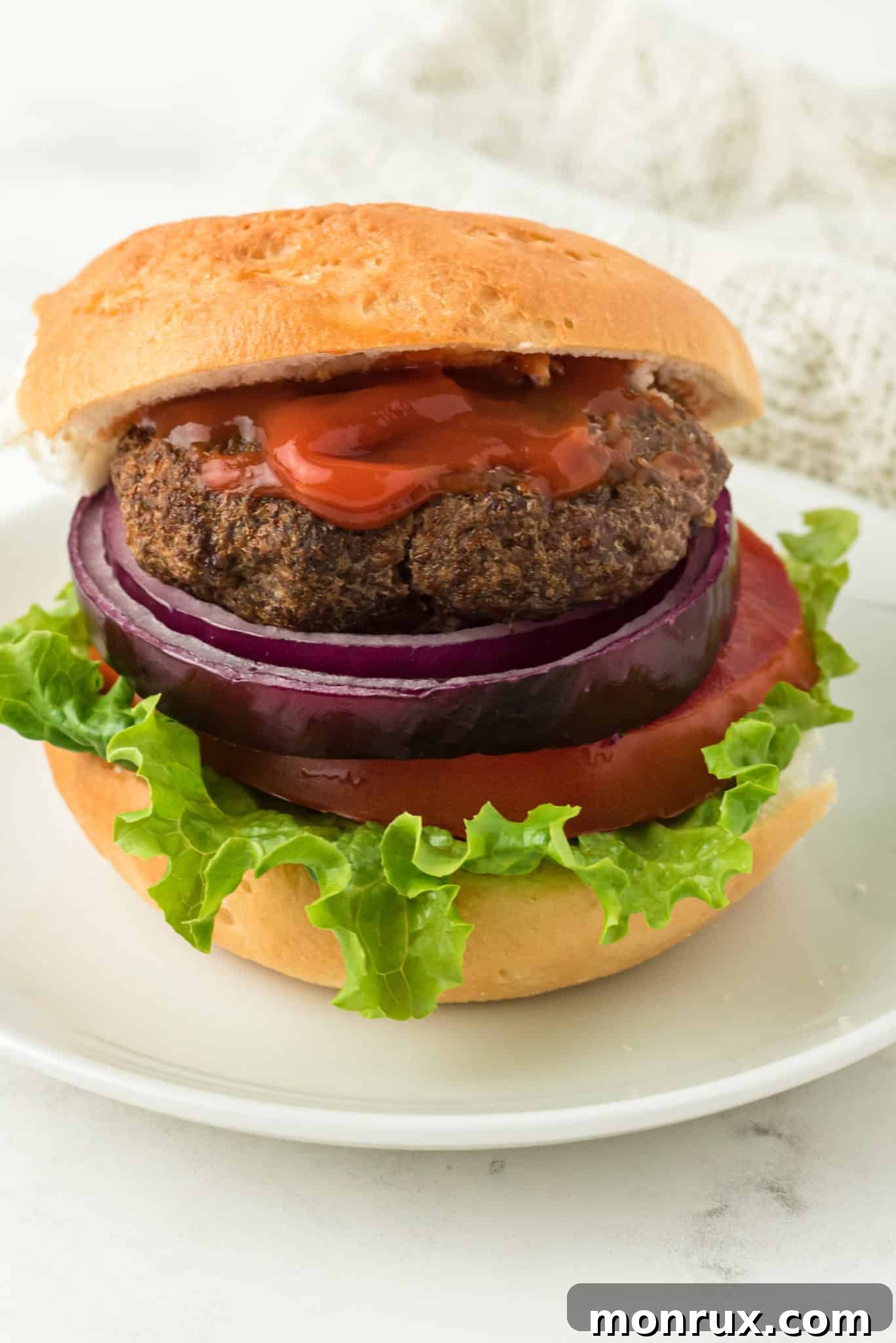 air fried hamburger served with bun and toppings.