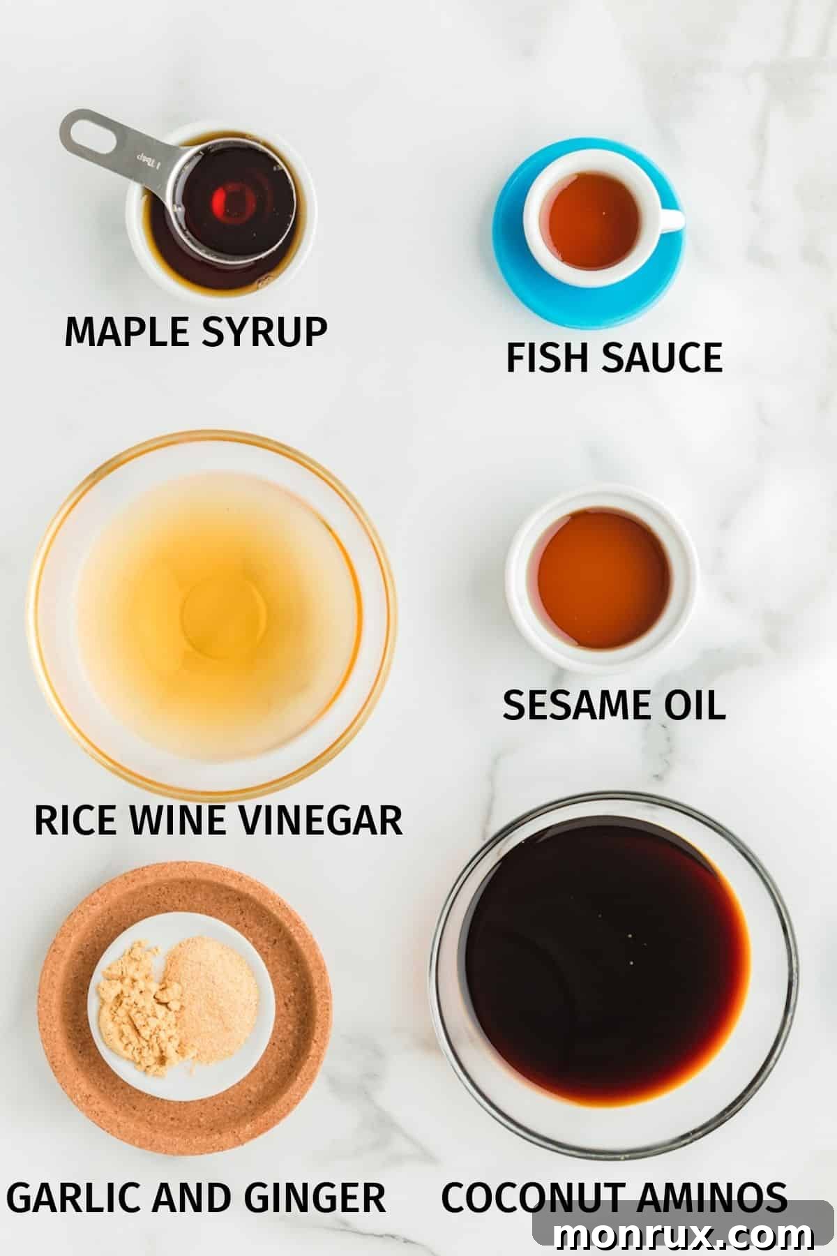 Ingredients laid out in small bowls, including coconut aminos, maple syrup, sesame oil, ginger, garlic, and rice wine vinegar, ready for making gluten free stir fry sauce.