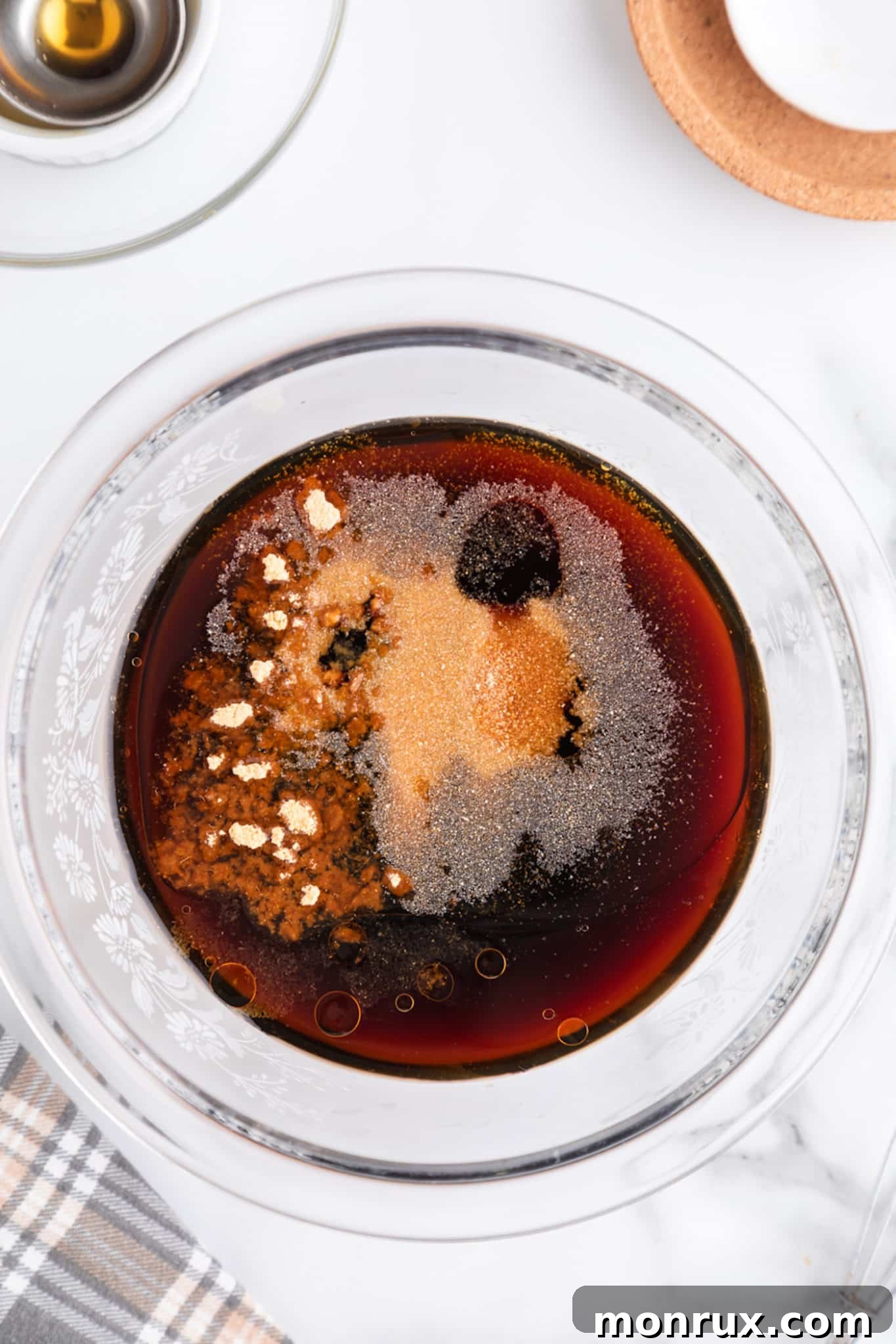 Top view of spices and seasonings before they are mixed into stir fry sauce, showcasing the individual components.
