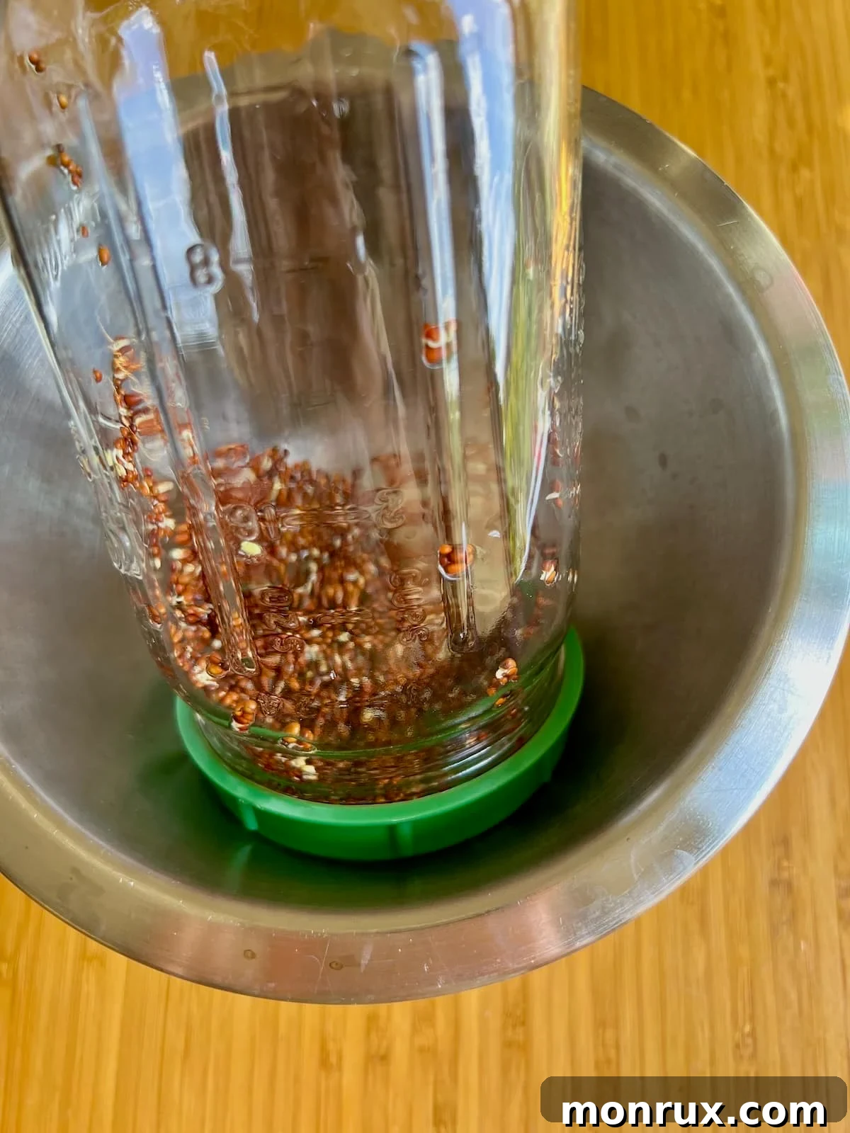 Broccoli sprout seeds in a jar, stored upside down at an angle in a bowl to ensure complete drainage and prevent mold growth.