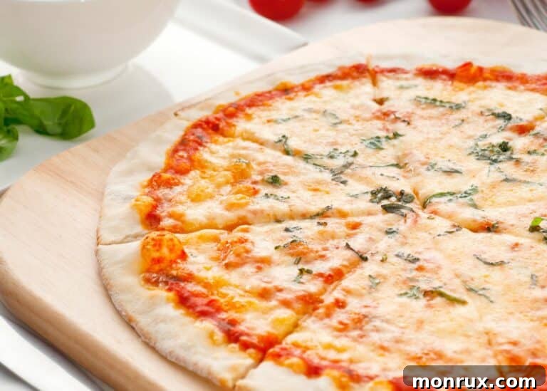 Cassava crust thin crust pizza, sliced on a cutting board.