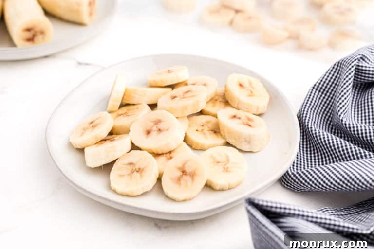 Frozen banana rounds on a small white plate.