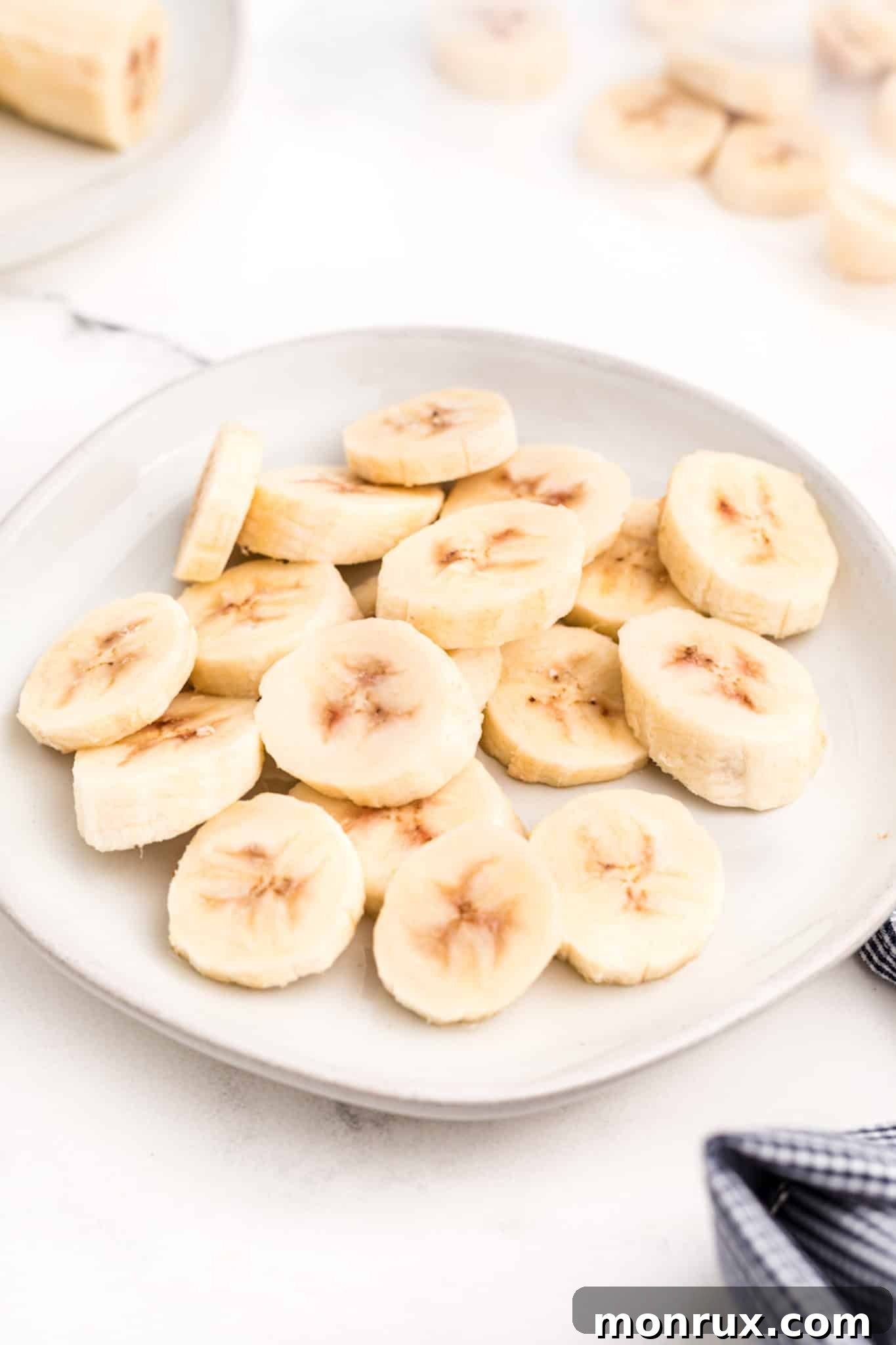 Frozen banana rounds on a small white plate.