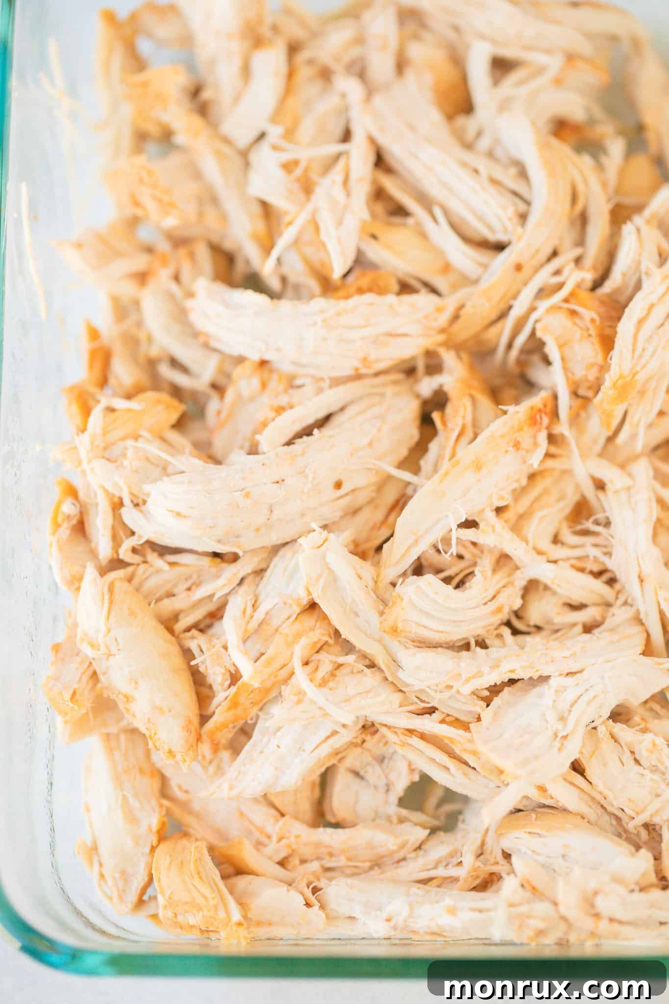 Perfectly shredded Instant Pot Salsa Chicken, ready for various meal applications.
