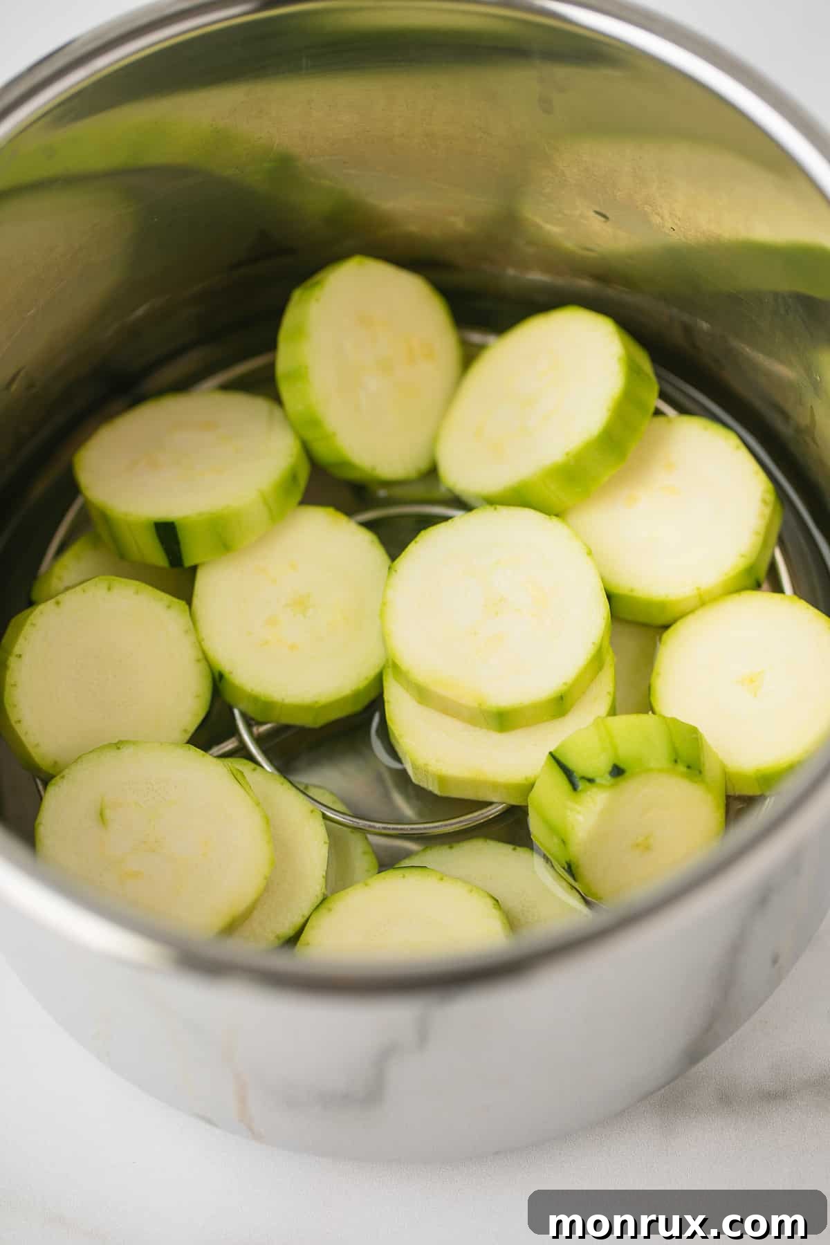 Perfectly steamed zucchini slices ready to serve from an Instant Pot.