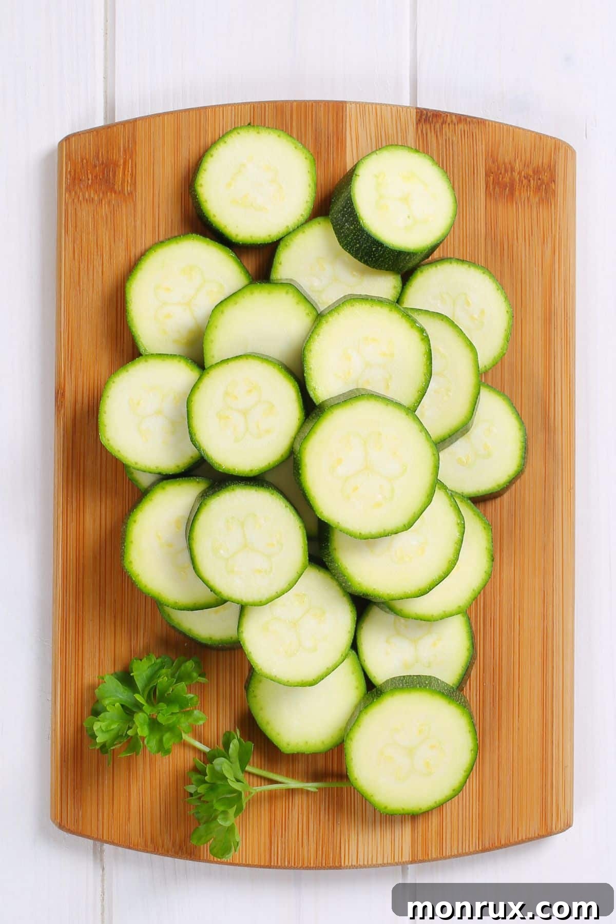 Fresh zucchini slices neatly arranged on a cutting board, ready for the Instant Pot.