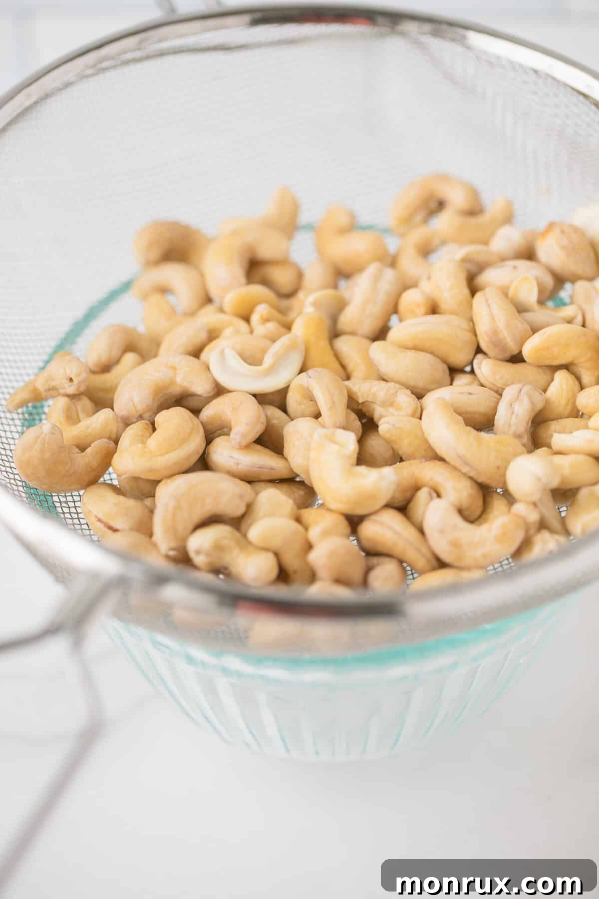 Soaked and rinsed cashews in a fine-mesh strainer.