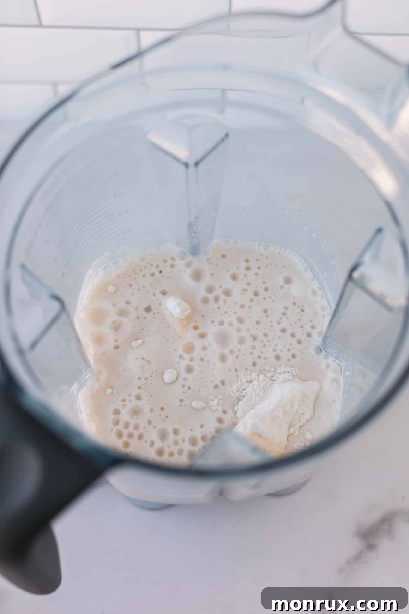 Ingredients for rice flour pancakes being blended in a high-speed blender.