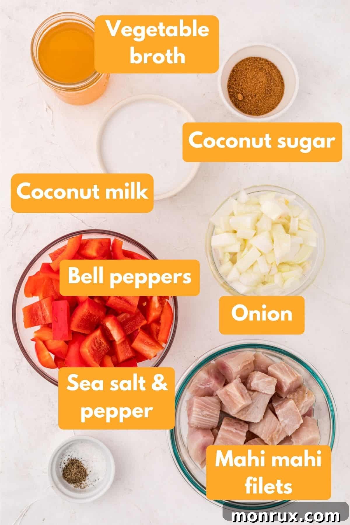 Assortment of fresh ingredients for Instant Pot Coconut Mahi Mahi stew, including fish fillets, bell peppers, onions, and coconut milk.