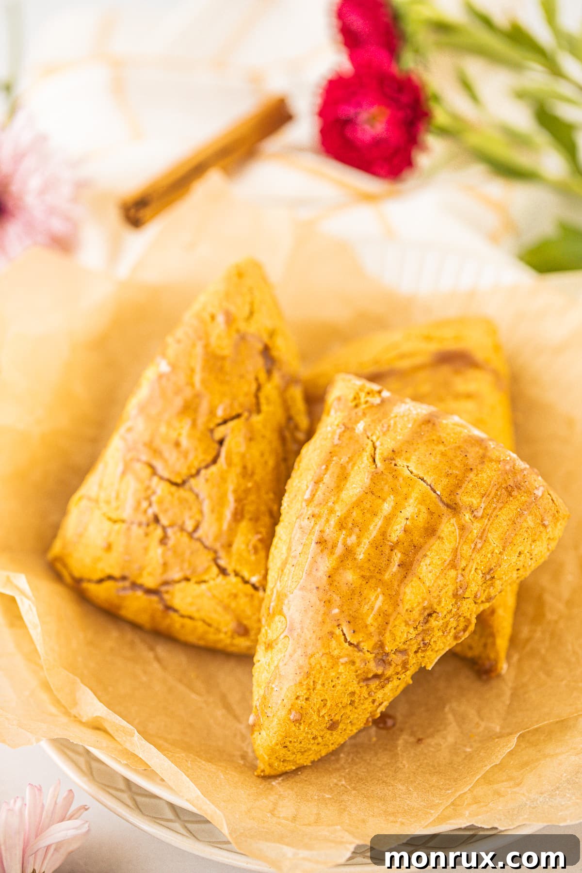 Two freshly baked pumpkin scones presented beautifully on a plate, ready to be enjoyed.