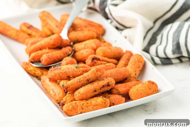 A platter presenting a generous serving of perfectly air-fried baby carrots.