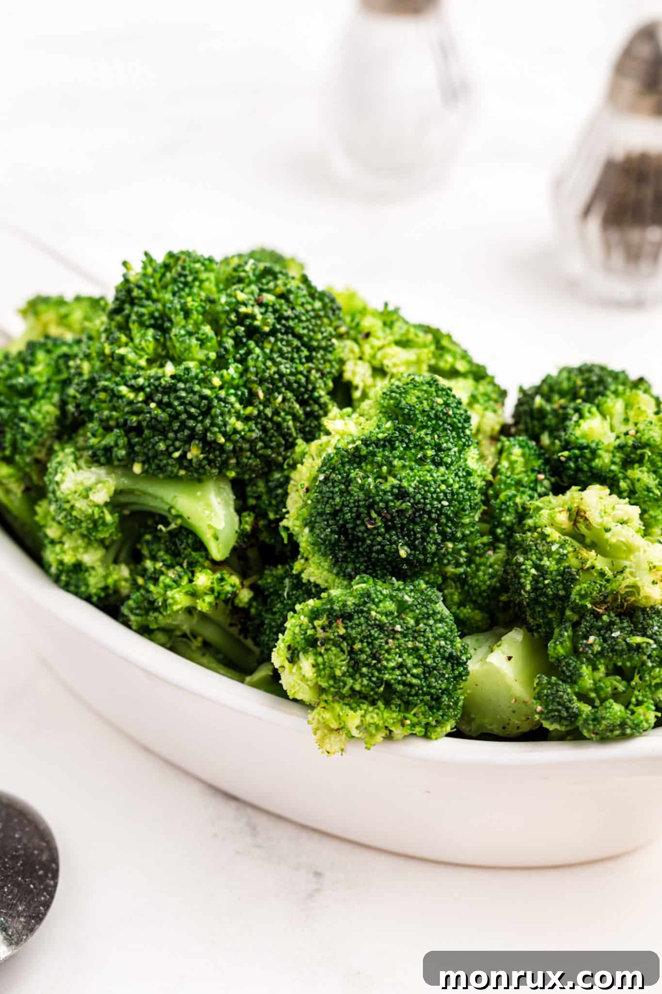 Instant Pot steamed broccoli served in a pristine white dish, ready to eat.