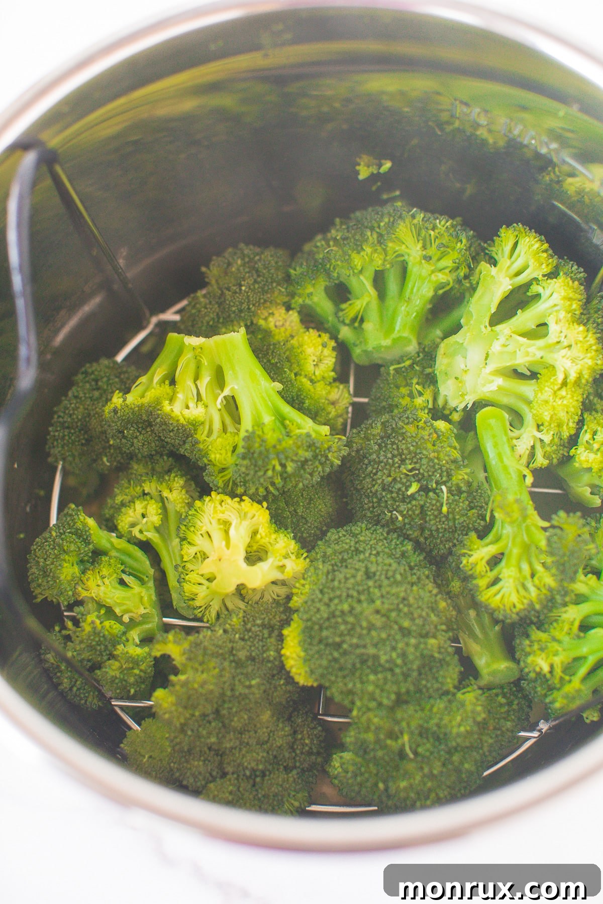 Steamed broccoli still in the Instant Pot, showing its vibrant green color.