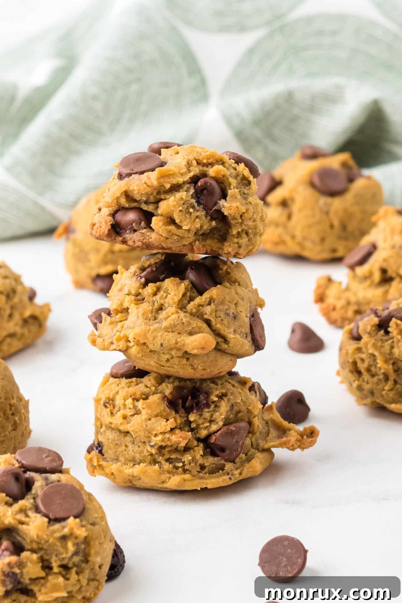 A beautifully composed stack of freshly baked chocolate chip cookies, artfully arranged to showcase their irresistible texture and perfectly melted chocolate.