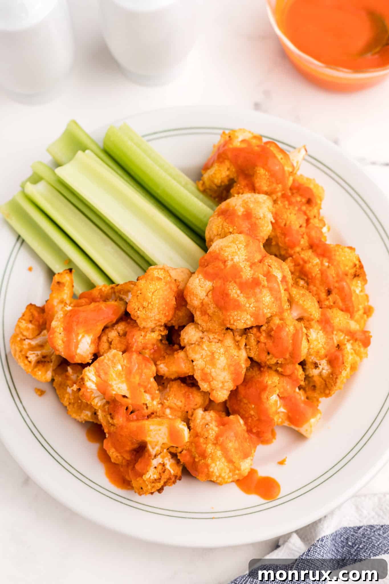 Crispy cauliflower wings generously coated in buffalo sauce, served with refreshing celery sticks.