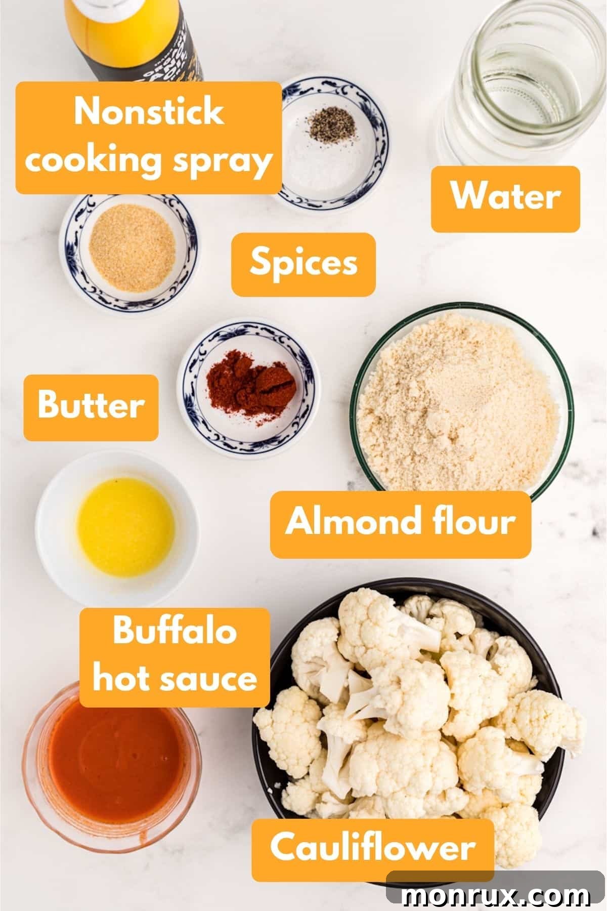 A vibrant selection of fresh ingredients including cauliflower florets, almond flour, spices, buffalo sauce, and butter, ready to be transformed into delicious cauliflower wings.