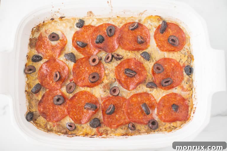 pizza casserole in a white baking dish ready to be served