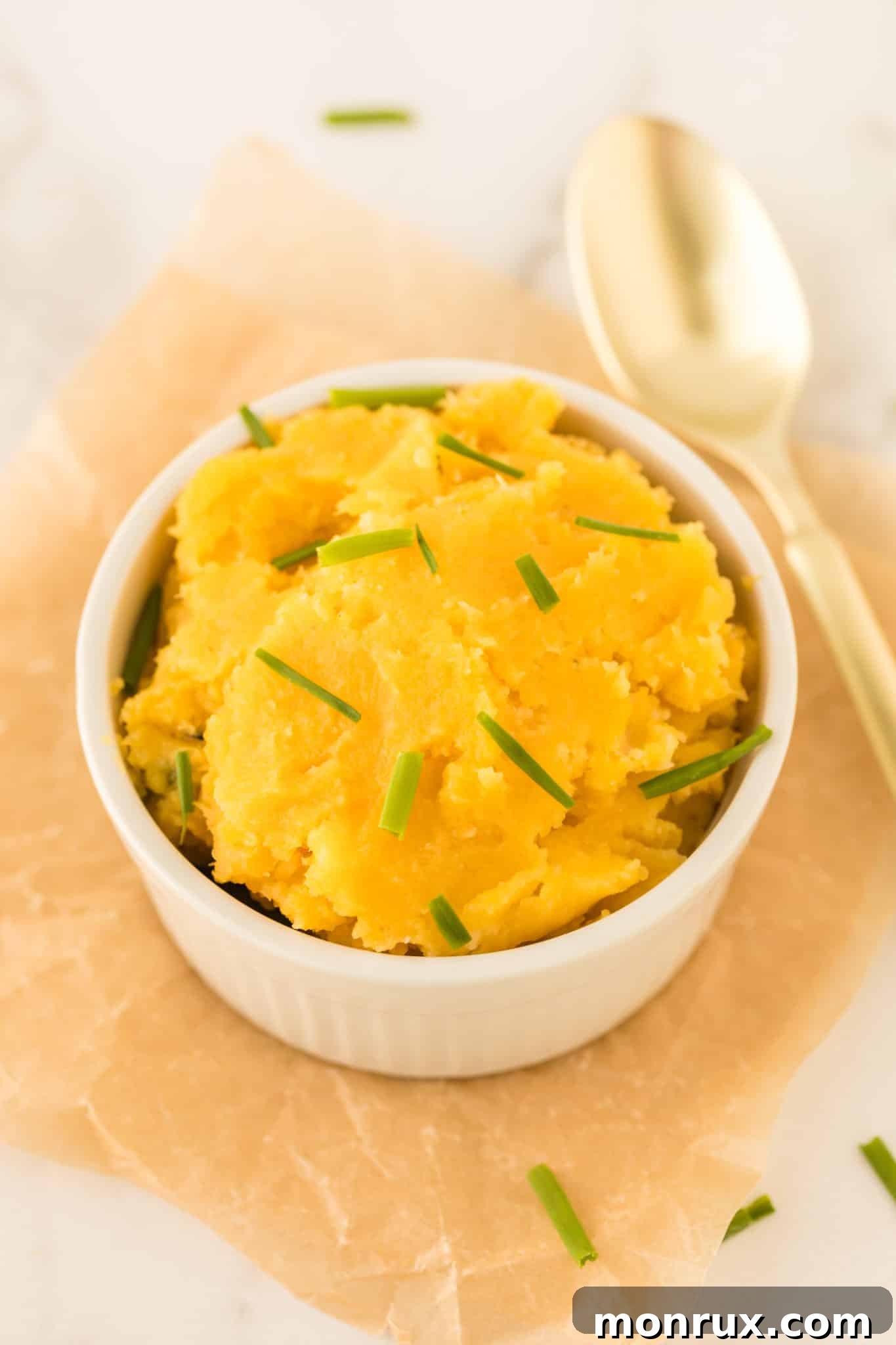 A bowl of creamy, cooked acorn squash puree, garnished and ready to serve.