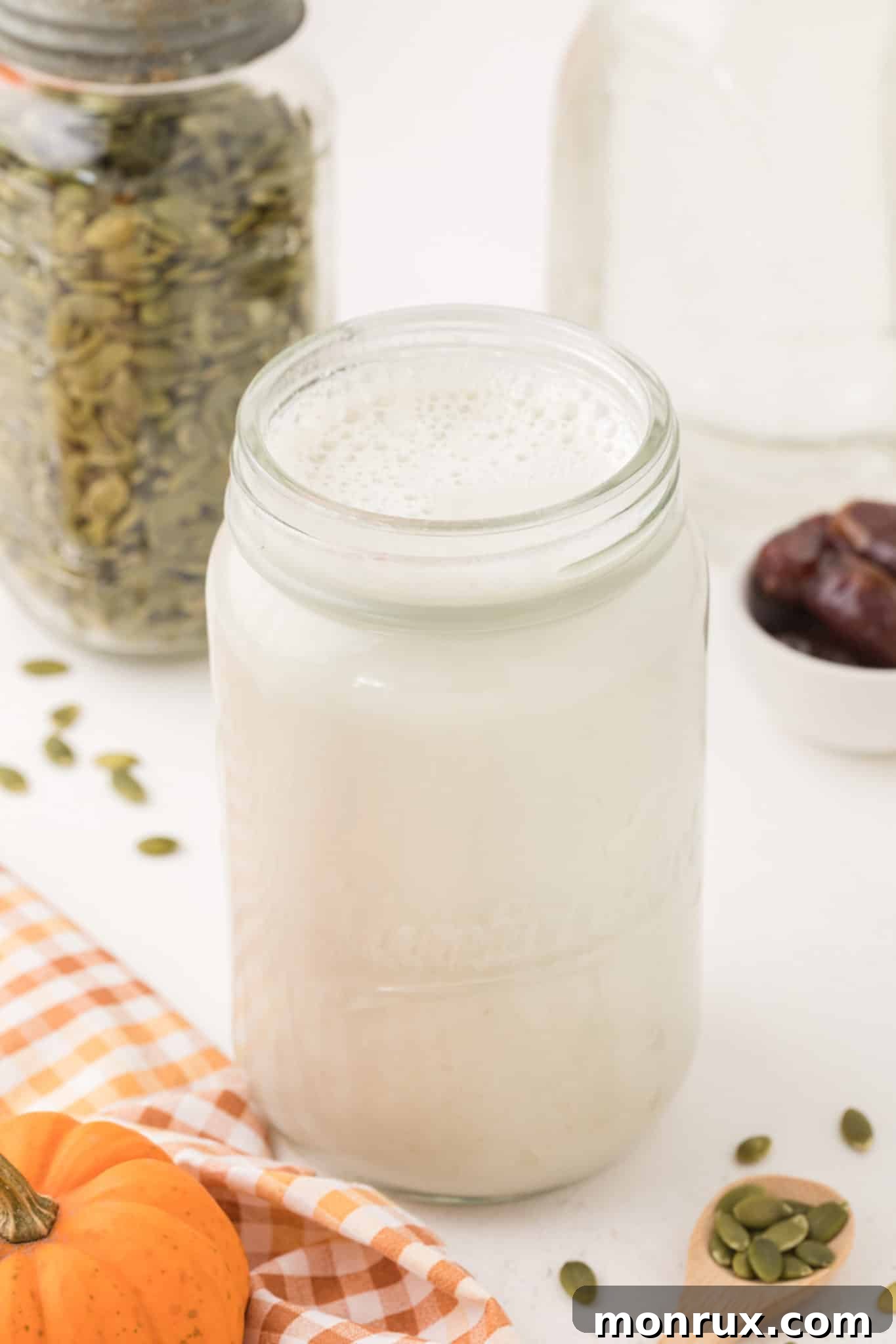 A glass jar filled with freshly made homemade pumpkin seed milk, ready to be enjoyed as a dairy-free beverage.