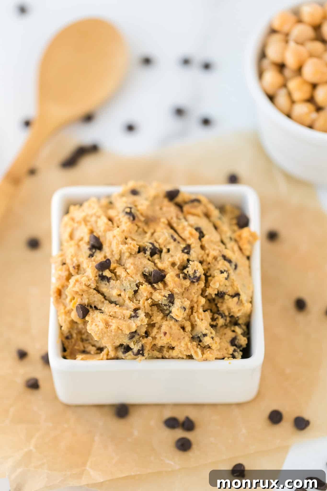 chickpea cookie dough served in a white square bowl.