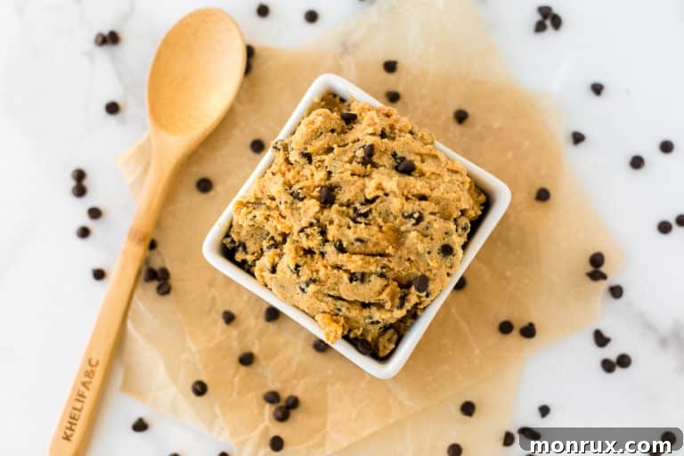 bowl of chocolate chip chickpea cookie dough surrounded by chocolate chips