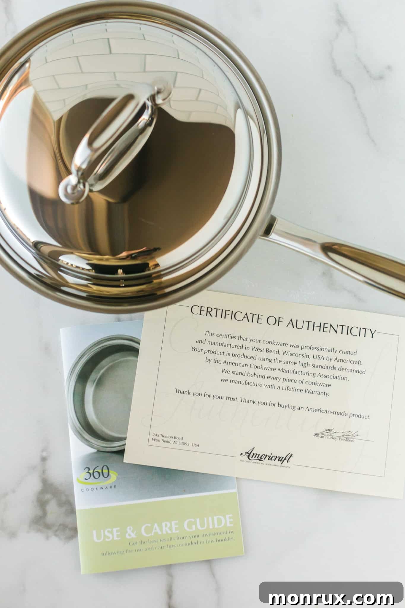 A high-quality stainless steel pot accompanied by its certificate of authenticity, showcasing the commitment to excellence from 360 Cookware.