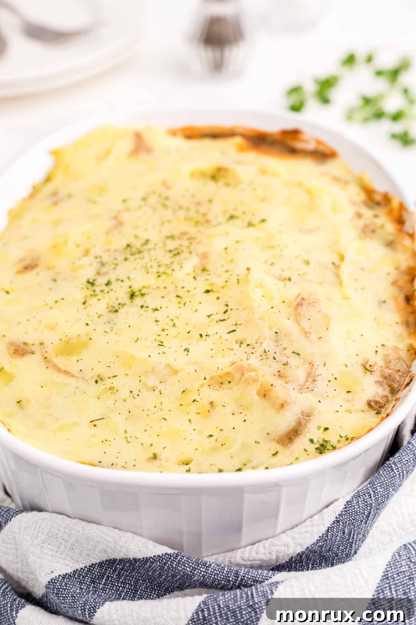 A beautifully baked vegan lentil shepherd's pie in a serving dish, ready to be enjoyed.