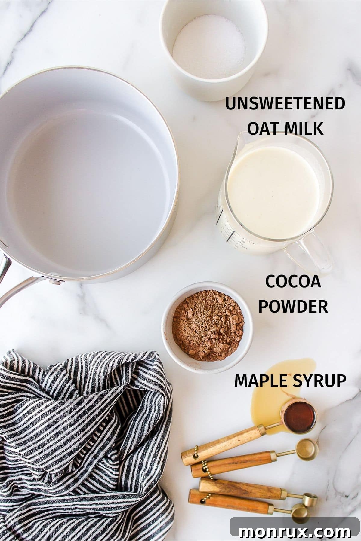 A vibrant flat lay image showcasing the simple yet essential ingredients needed to make delicious oat milk hot chocolate.